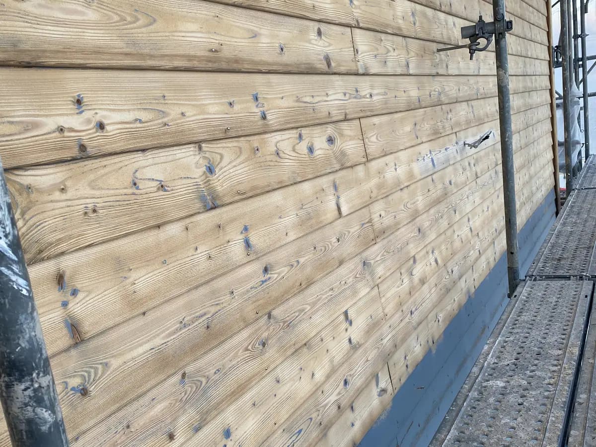 Aérogommage de la façade en bois peinte du bâtiment LANDI à Orbe - Après intervention